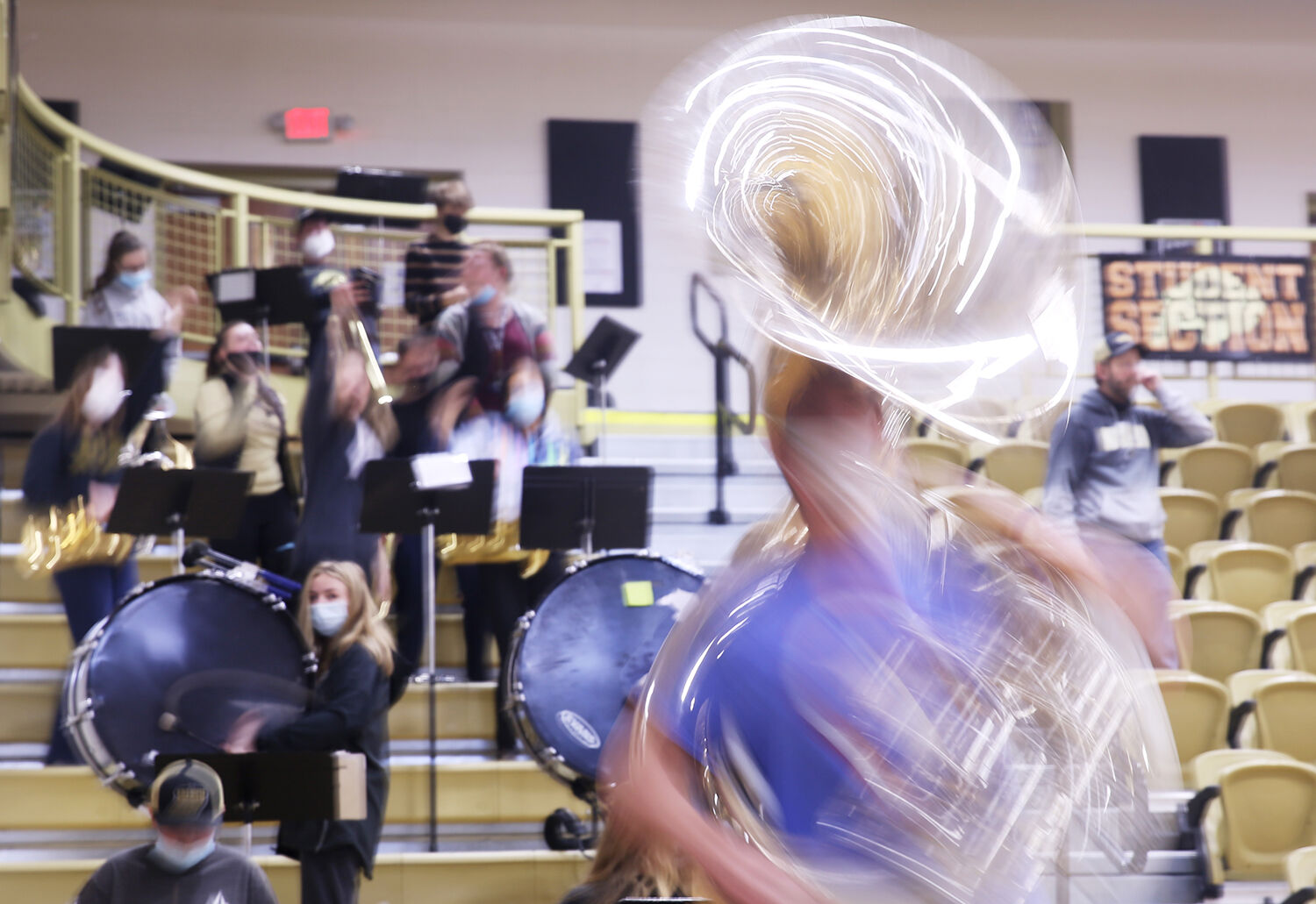 Members of the pep band jump and spin